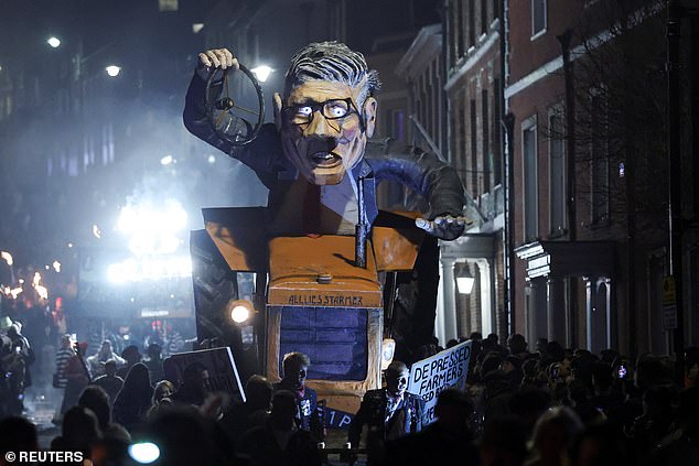 An effigy of the Prime Minister at the wheel of a tractor without a steering wheel was paraded through the town centre