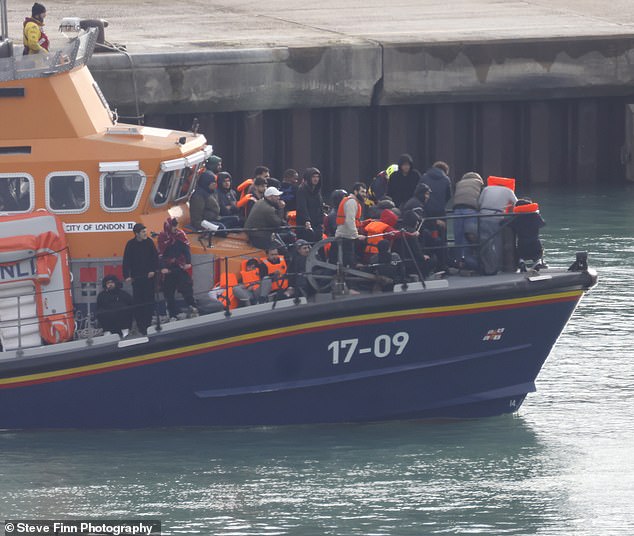 Migrants were pictured crowded onto the bow of the RNLI lifeboat, 'City of London II', as it made its way into Dover