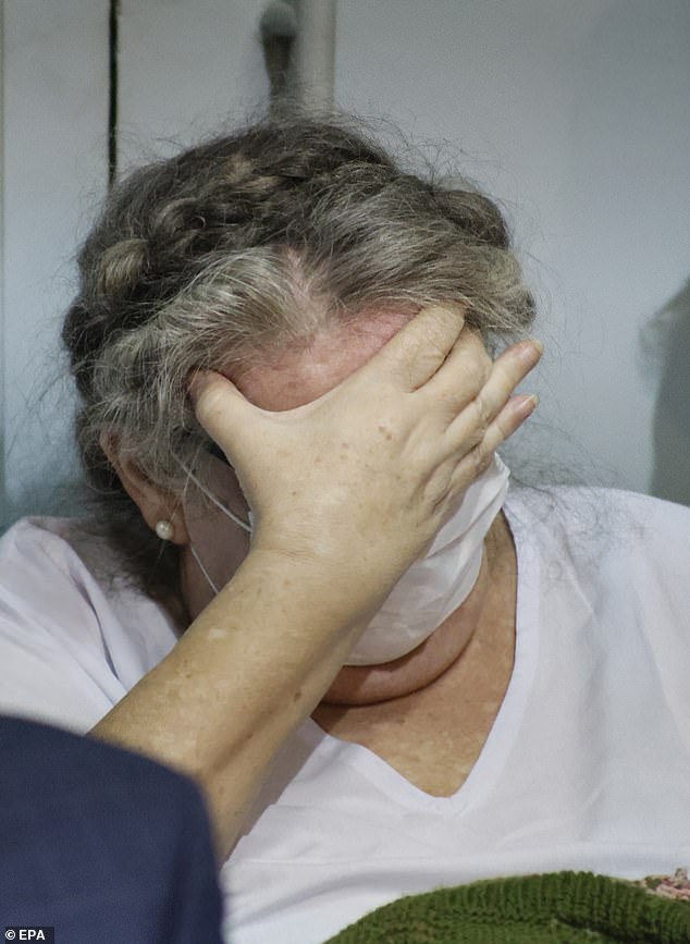 Lindsay Sandiford kept her face buried in her hands during a handover ceremony at Kerobokan Prison in Bali