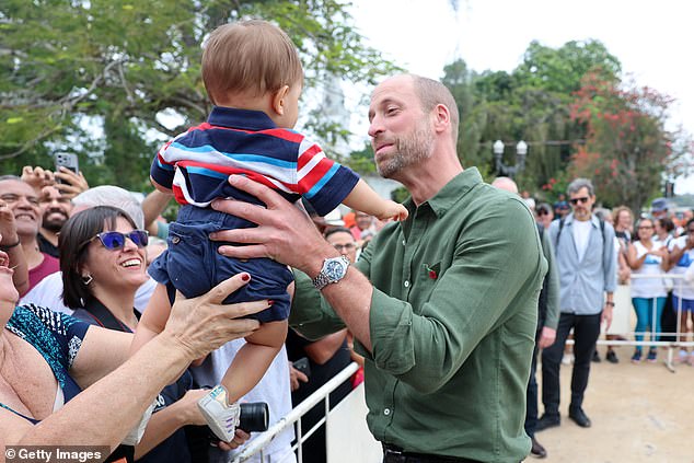 The future King had a cuddle with 10-month-old Joaquim Monteiro during his walkabout in Paquetá, located in Guanabara Bay