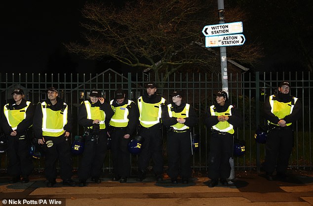 Banks of officers stand on duty on a day when police vehicles, dogs and drones descended on Birmingham