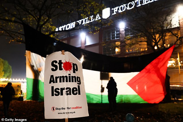 A large Palestine flag is unfurled in the shadow of the Premier League ground on Thursday night