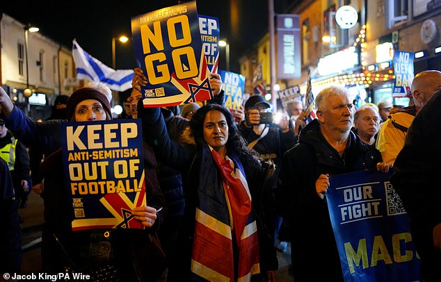 Pro Israel supporters are led to Villa Park waving banners protesting the ban against Maccabi Tel Aviv