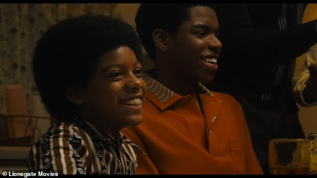 A child Michael was seen as he sat at a table with his family as the voice continued, 'Honor your past and embrace the future. That's what people want'