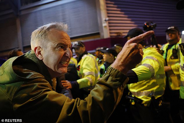 A fan points at a rival supporter as tensions mount in the minutes before kick-off