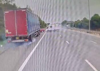Terrifying moment car towing caravan loses control on motorway as it overtakes lorry before flipping onto hard shoulder