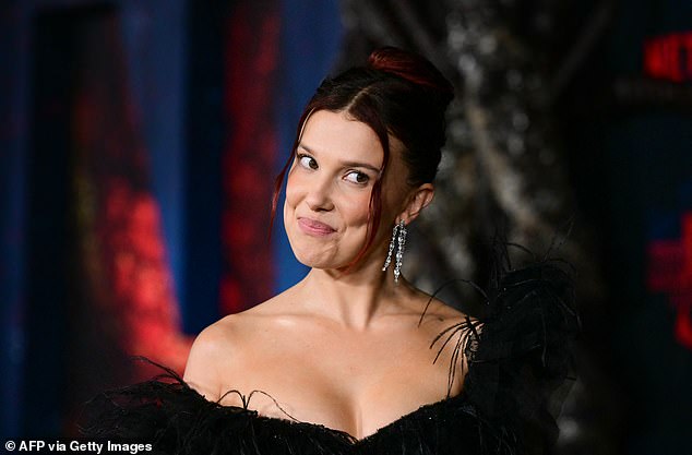 She complemented the revealing sheer outfit with her dyed-red hair, which was styled up in a bun with delicate curled strands dangling to frame her impeccably made-up face