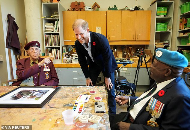 Britain's Prince Harry talks with war veterans Ozzie Reece and Ed Marshall as he meets with some of Canada's oldest veteran