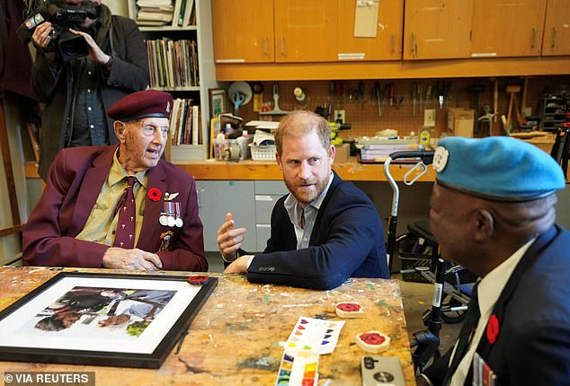 Harry chatted to the heroes, who were painting poppies