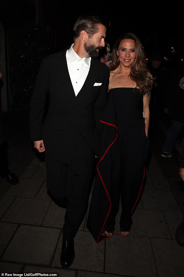 The couple looked smitten as they held hands outside the event