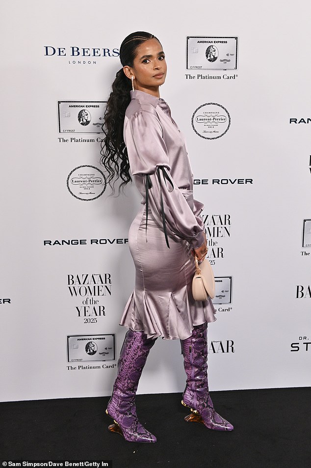 Boxer Ramla Ali looked stylish in a satin pink dress and snake print knee-high boots