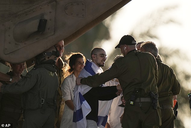 Rom Braslavski walks off a helicopter at the Sheba Medical Center in Ramat Gan, Israel, Monday, Oct. 13, 2025