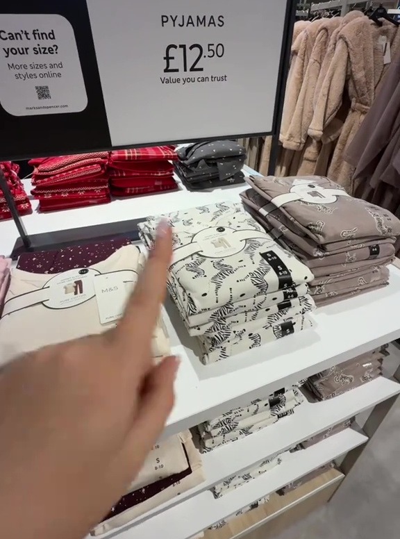 A display of pyjamas in a store, with a sign showing "PYJAMAS £12.50 Value you can trust".