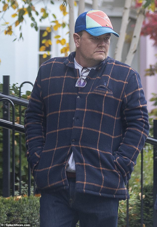 With his signature glasses off, Alan attempted to keep a low-profile for his morning stroll through the capital