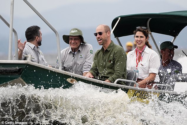 Prince William, Prince of Wales (centre) rides in a boat during a tour of the Guapimirim mangrove area in Guanabara Bay