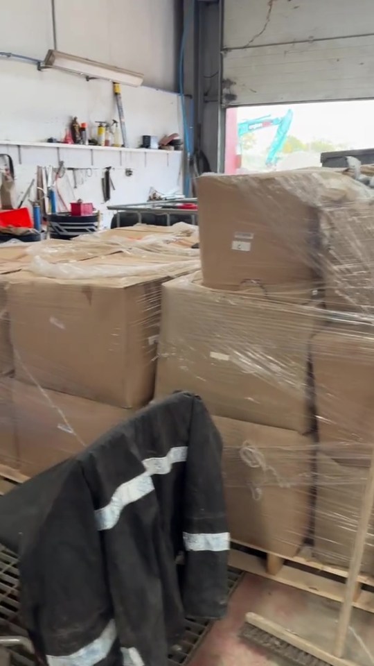 Pallets of boxes wrapped in plastic in a warehouse.