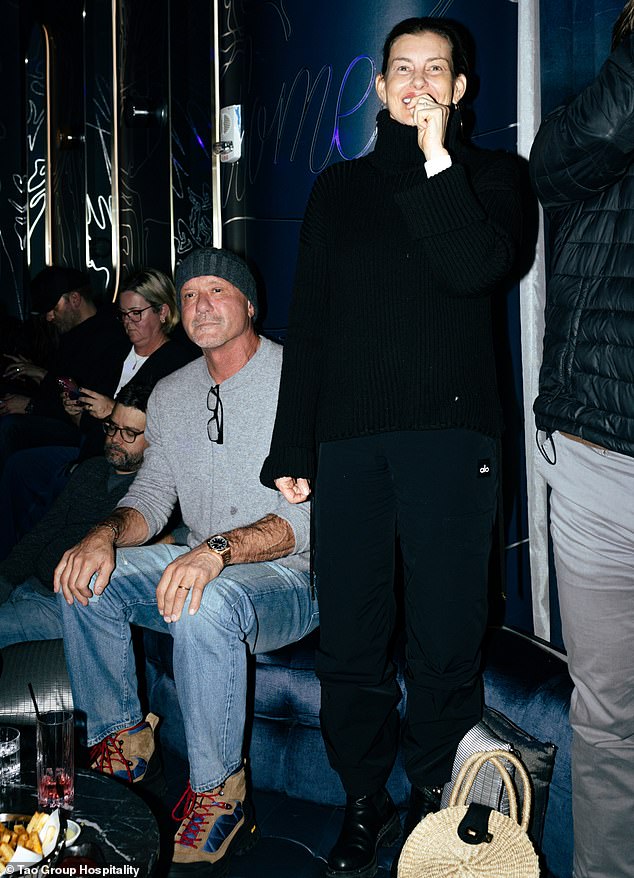 A source who was also in attendance for the performance told the Daily Mail, 'Tim kept rotating both shoulders like he was sore'