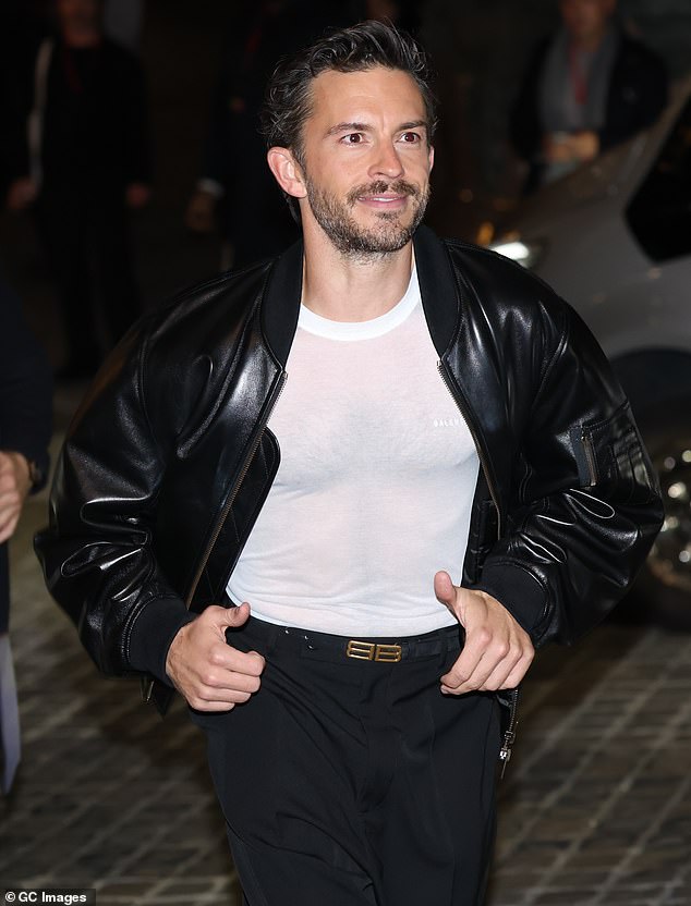 Jonathan Bailey flashed a glimpse of his hairy chest beneath a sheer Balenciaga T-shirt which he teamed with a leather jacket