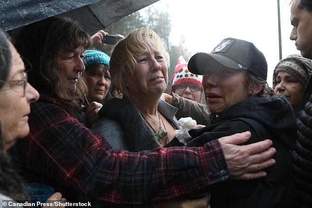 Picture us Karen Pasitney crying on Thursday in the warms of her daughter Katie (right)