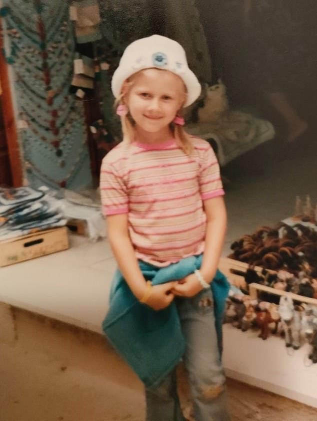 Julia Wandelt as a four-year-old on holiday in Greece wearing a pink t-shirt and a white hat