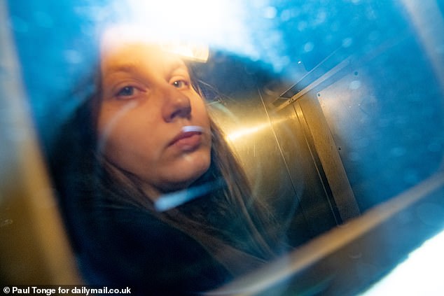 Julia Wandelt, 24, looks out from the back of a police van after being found guilty of harassing the McCanns but cleared of stalking them