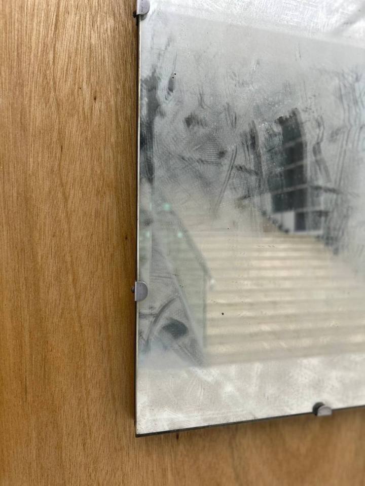 Artist Chen Sung-chih’s piece, "Inverted Syntax – 16", featuring a smudged mirror on a wooden board.