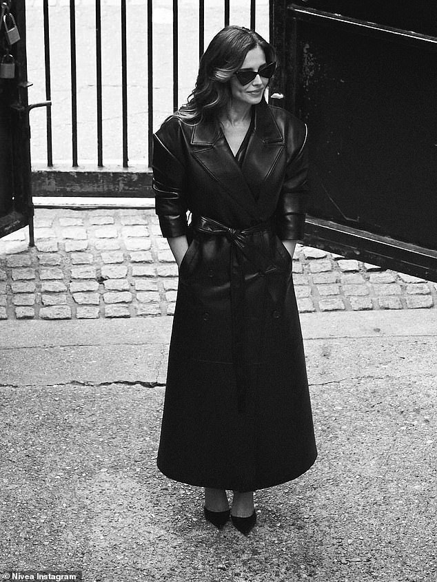 Meanwhile, in another stunning snap, Cheryl donned a classic black leather trench coat, featuring a double-breasted button-up fastening and a belt to cinch in her waist