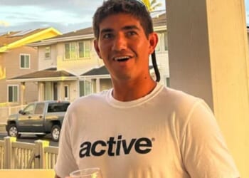 Shark savagely mauls lifeguard leaving him consciousness as terrified beachgoers see 'big red stain' in the water