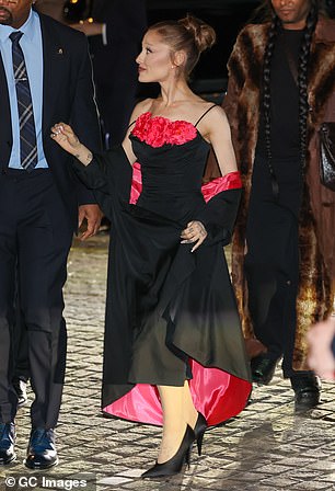 Ariana, 32, who plays Glinda The Good in the fantasy films, looked sensational in a chic black gown with pink floral embellishments