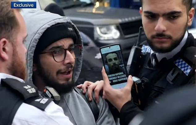 Police compare Brahim Kaddour-Cherif with his wanted photo during his arrest on Friday