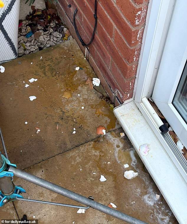 Egg shells and insides stick to the patio floor of Celine's home after the attacks