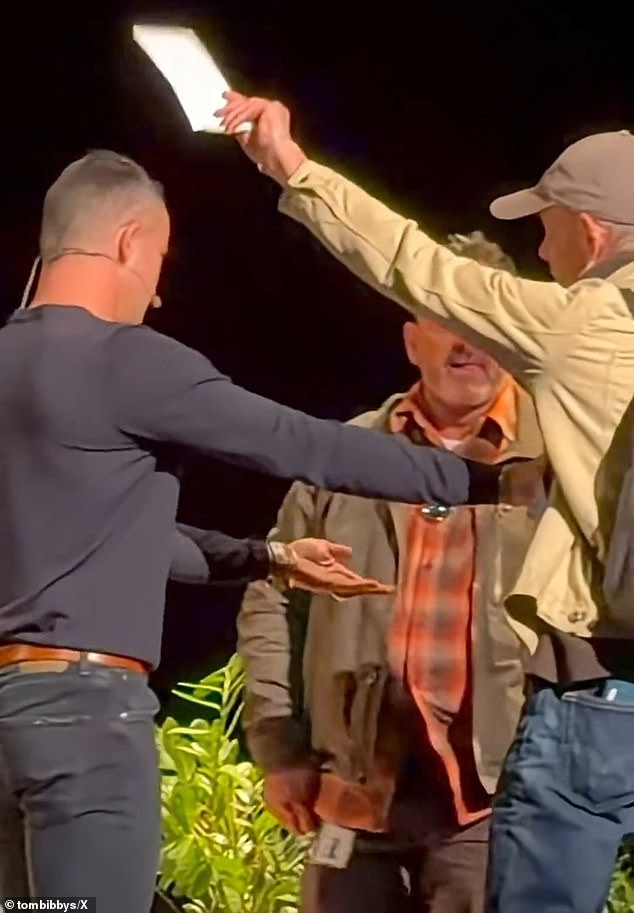 Dramatic video captured the moment a man with a backpack bursts in, waving a white envelope and declaring that he has a subpoena for the tech mogul (pictured)