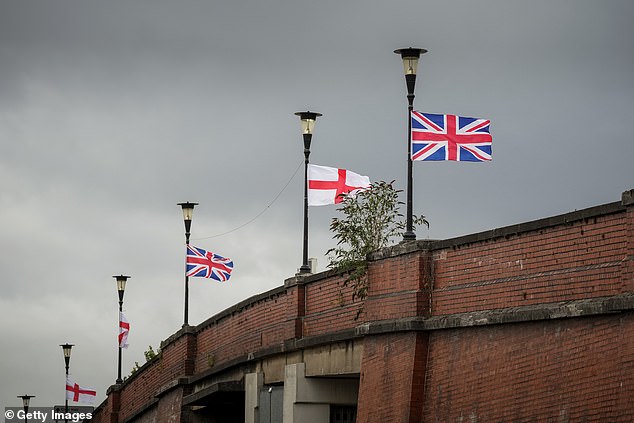 The Union flag and English flag on lampposts in Ellesmere Port. Gove argues the Raise The Colours counter-protest, with Union Jacks appearing on lamp-posts and motorway bridges, was a reaction from those who felt their British identity threatened