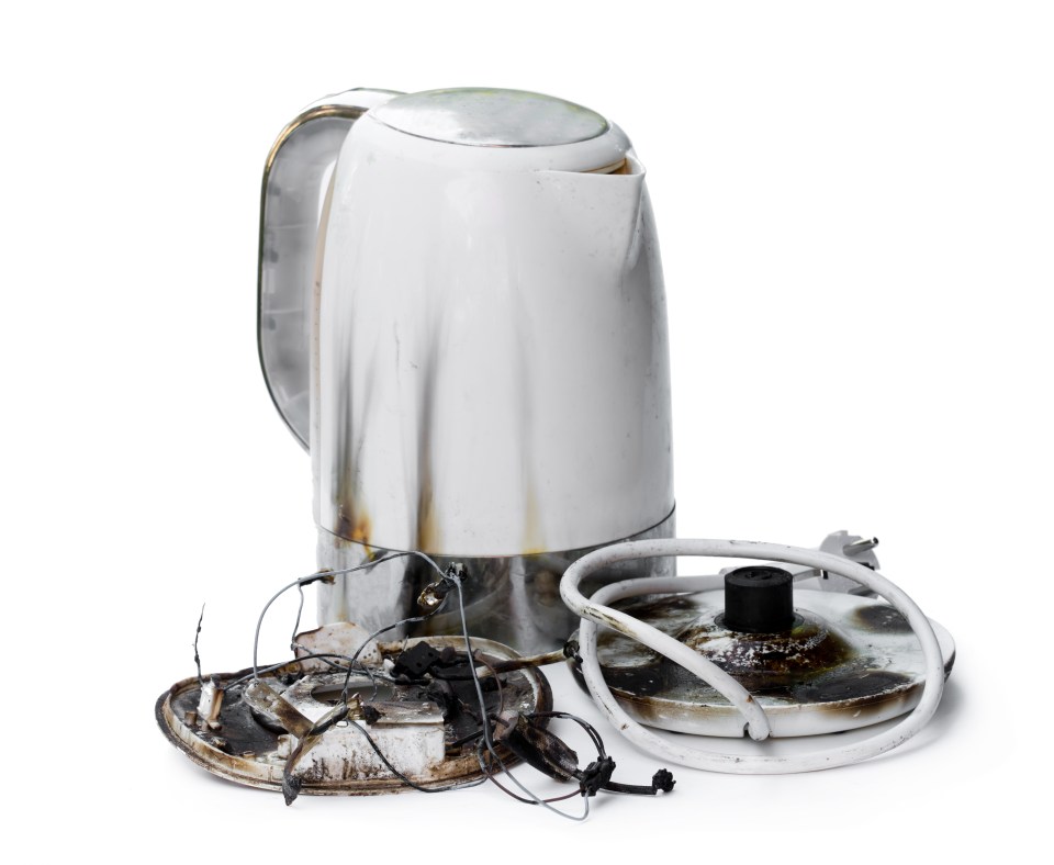 An electric kettle that caught fire and its melted and burnt base.