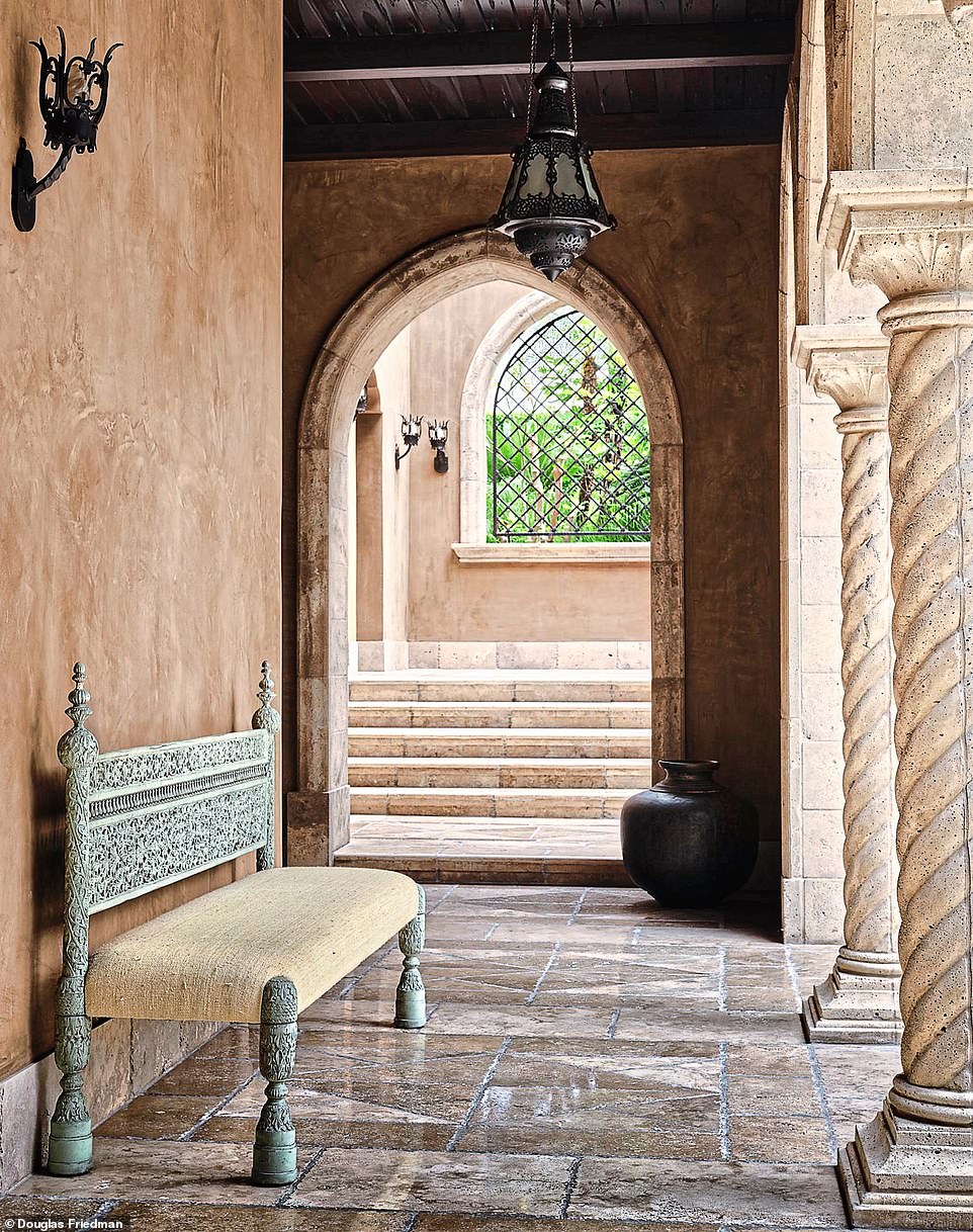 Leading to the guest suites is this calm area, decorated with custom-made hanging lanterns from Mustapha Blaoui, in Marrakech. The carved bench, by Lawrence Bullard, is clad in fabric from vincentvanduysen.com. Try nkuku.com for a range of upholstered benches.