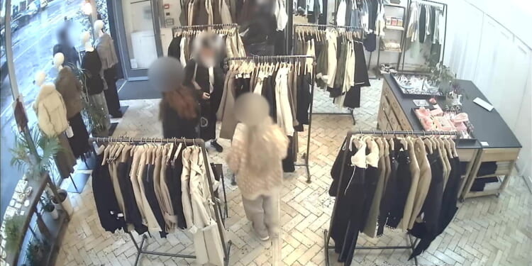 Shocking moment 'shoplifting' women storm into boutique & steal £2k of clothing after ripping jackets from mannequins