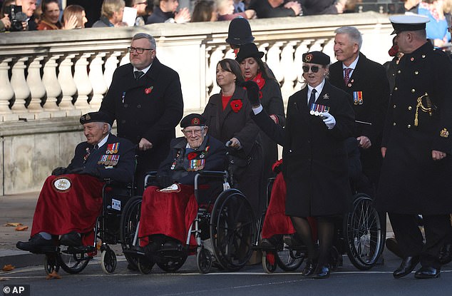 Veterans arrive at the beginning of the Remembrance Sunday ceremony at The Cenotaph on Whitehall in London, Sunday Nov. 9, 2025. (Toby Melville/Pool Photo via AP)