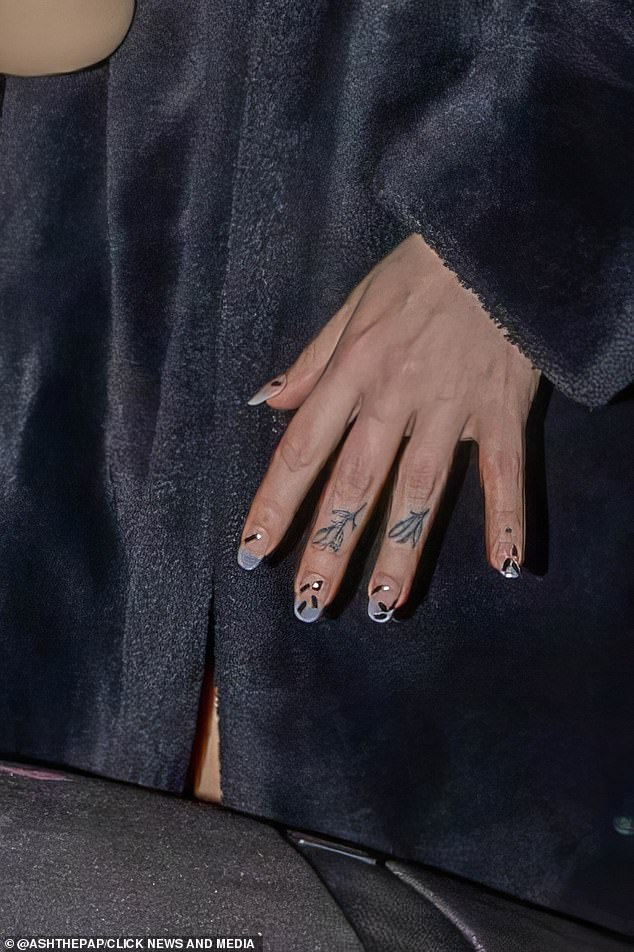 In a picture zoomed in on her nails, Shona was seen without her engagement as she made her way to departures