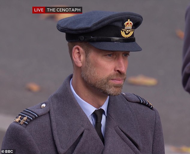 Prince William, wearing his RAF uniform in the rank of Wing Commander with a greatcoat, poppy and sword, at the Remembrance Day service today