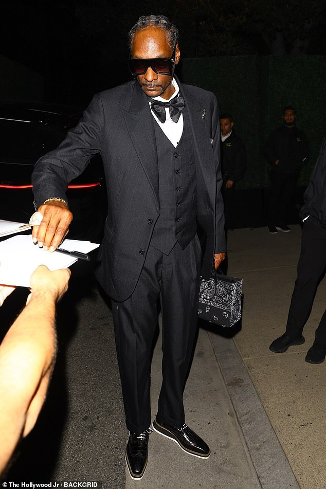 Meanwhile Snoop Dogg wore a three-piece suit and bow-tie, with the fashion forward touches of shades and a handbag