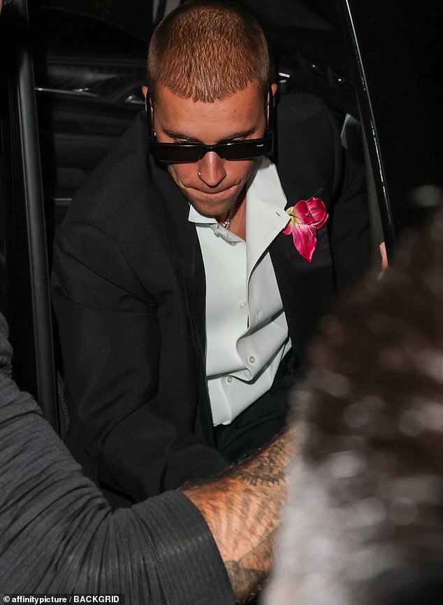 Justin Bieber forewent his usual dressed-down baggy attire and turned up in a debonair black suit, even putting a pink flower in his lapel