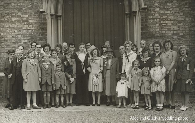 Alec and his wife Gladys are pictured with their family and friends on their wedding day on July 21, 1945