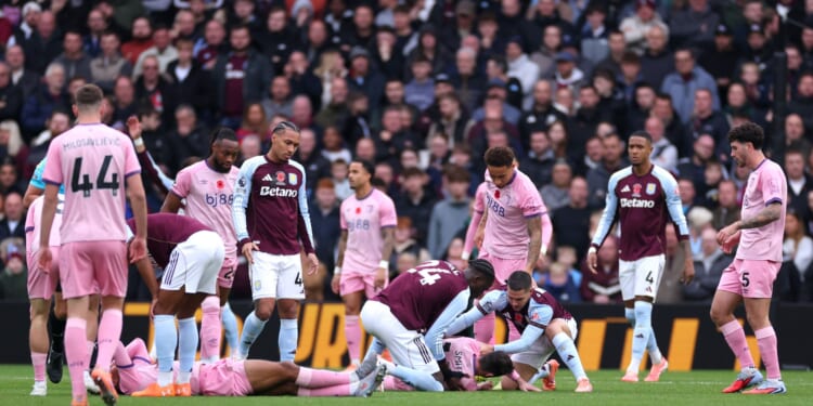 Bournemouth stars Tyler Adams and Adam Smith collapse to floor with nasty head injuries as Aston Villa clash suspended