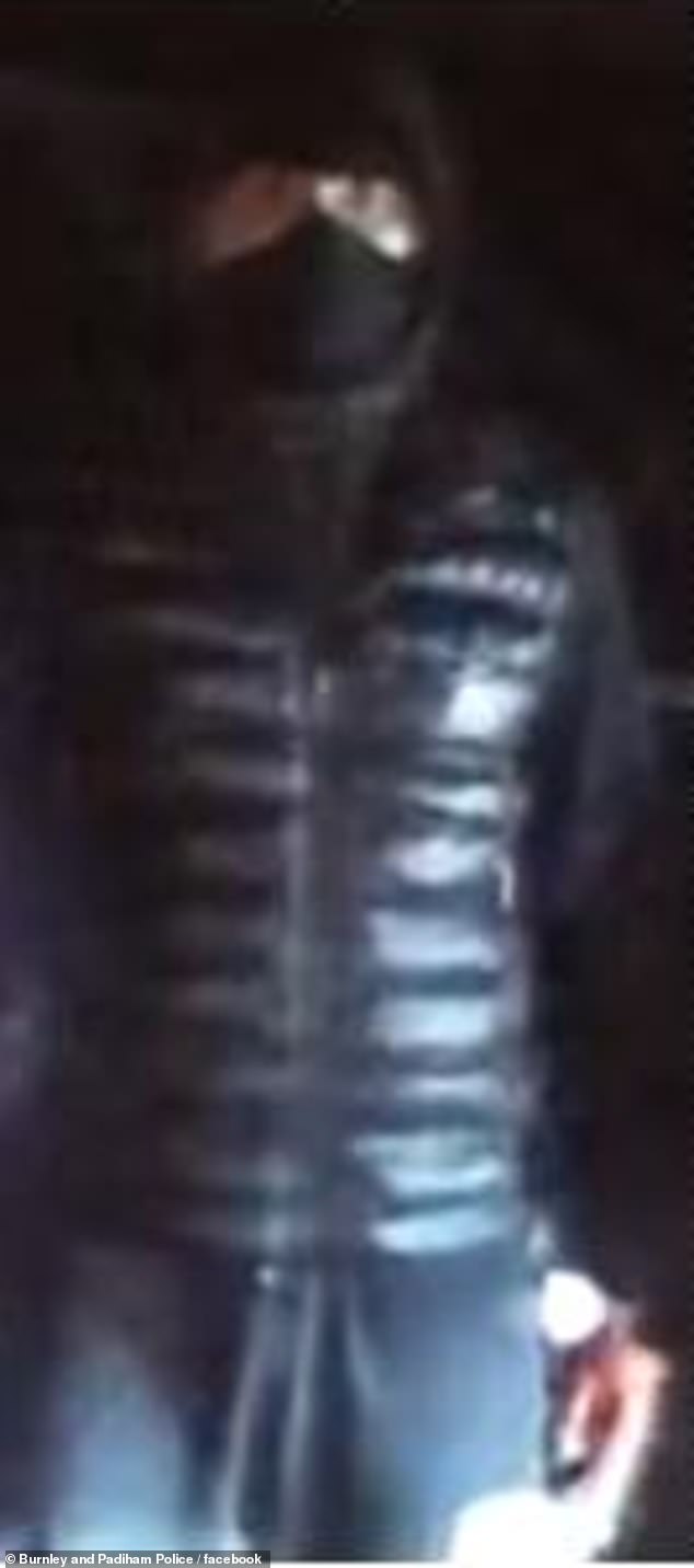 Colour CCTV still of the masked yob wanted over firework incident in town centre street