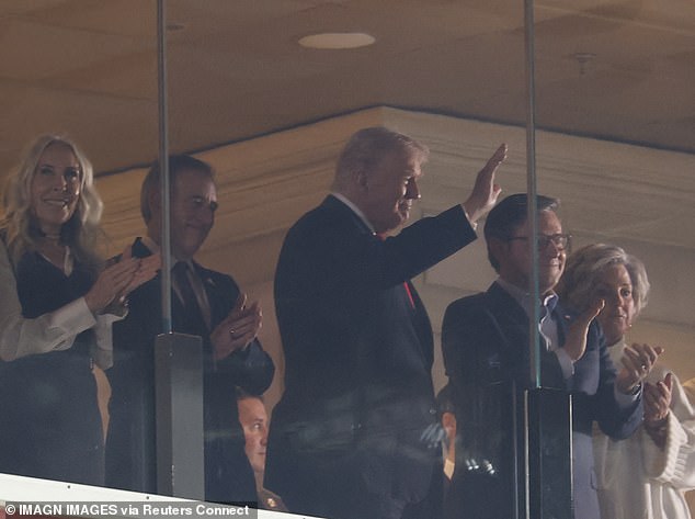 Trump waves to the fans in the stadium who were trying to get a glimpse of the president