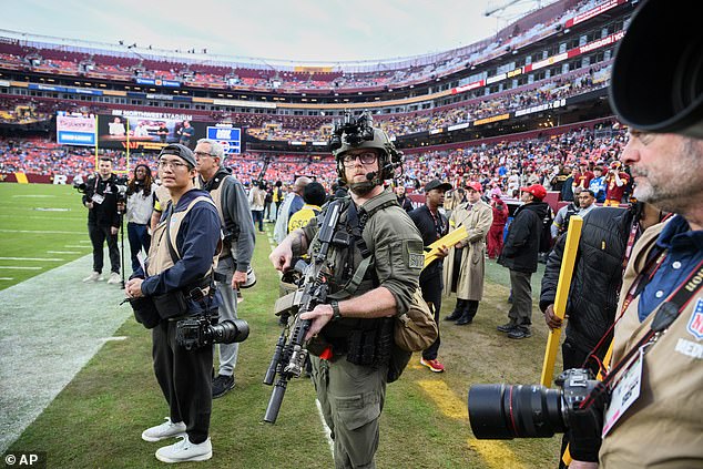 Heavily armed law enforcement stand guard on the sideline before kickoff in Washington DC
