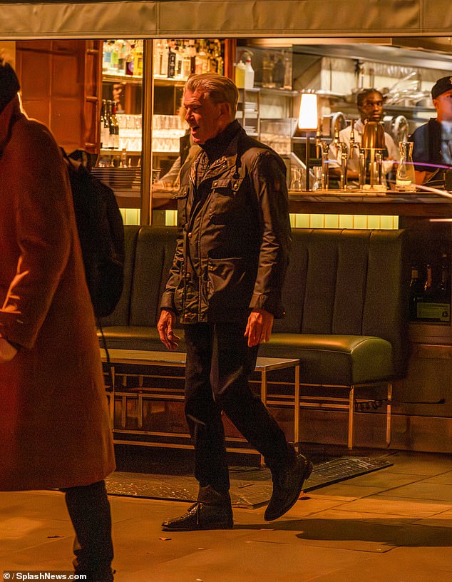 The actor was pictured beaming as he left the restaurant in a black jacket