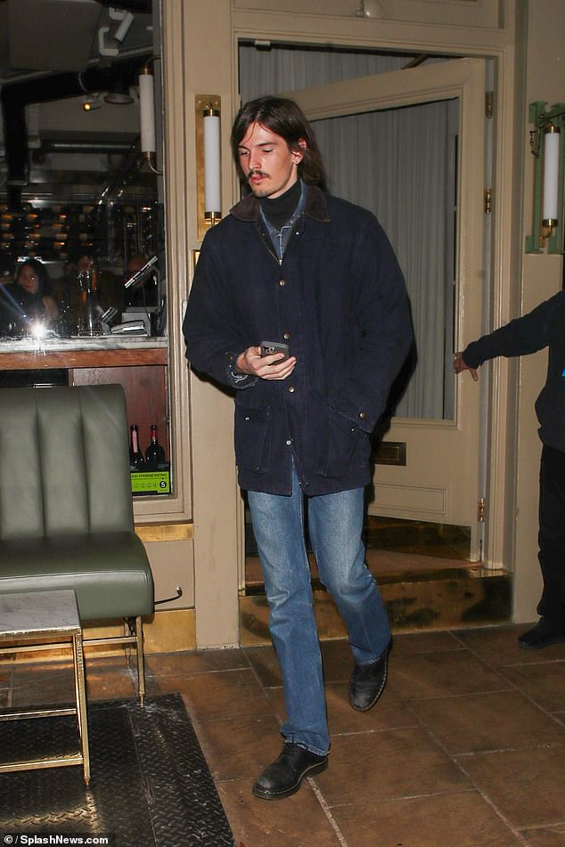 Model Dylan cut a cool figure in jeans and a navy jacket