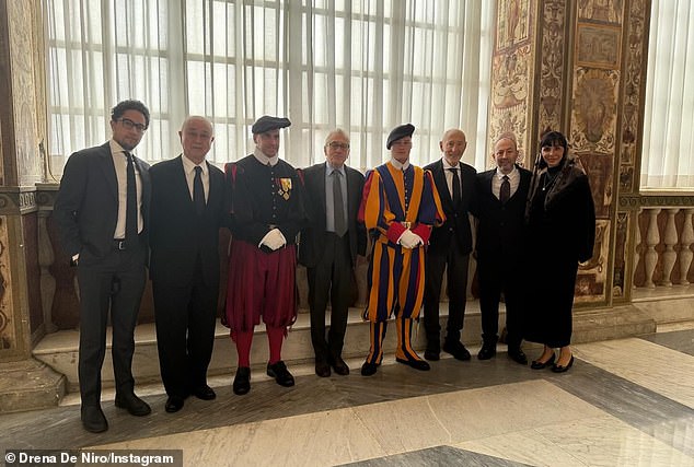 The family posed alongside some of the staff members at the Vatican
