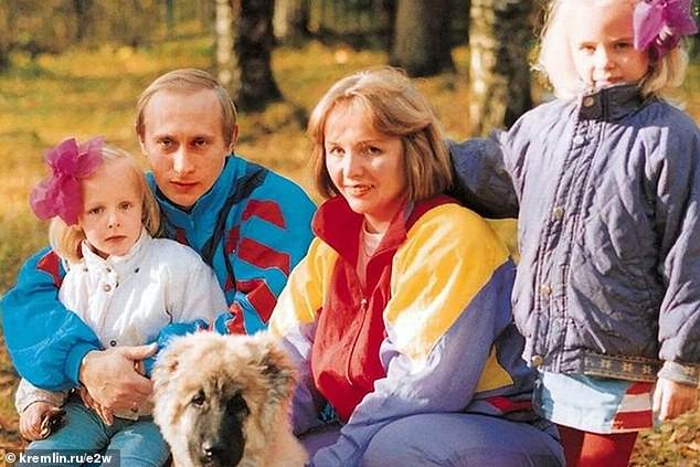 Putin with his family - his second daughter, Tikhonova, left, is being backed one of Putin's top allies to take over from him